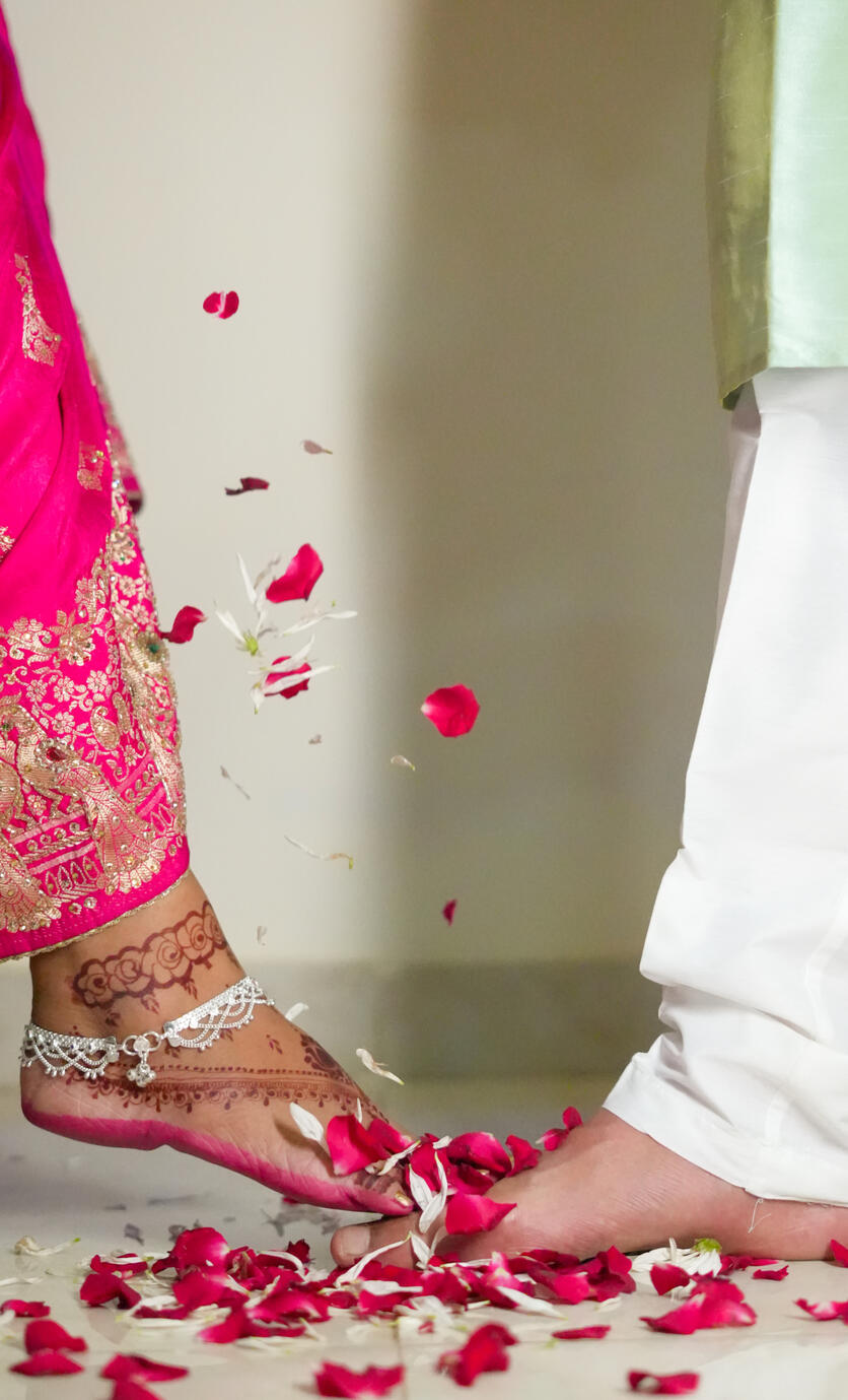 Beautiful candid wedding detail shot capturing flower petals and traditional bridal elegance during Shweta and Sandeep Rawat’s ceremony.