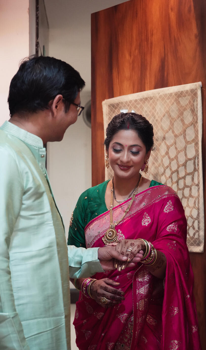 Bride Shweta sharing a candid traditional wedding moment with Sandeep Rawat during their intimate celebration.